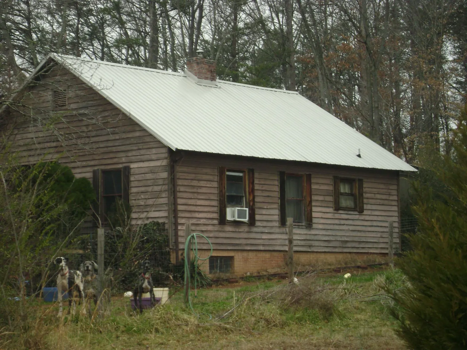 White metal roof on an old wood sided farmhouse, from a Asphalt Shingle Roof Repair job in Travis Afb
